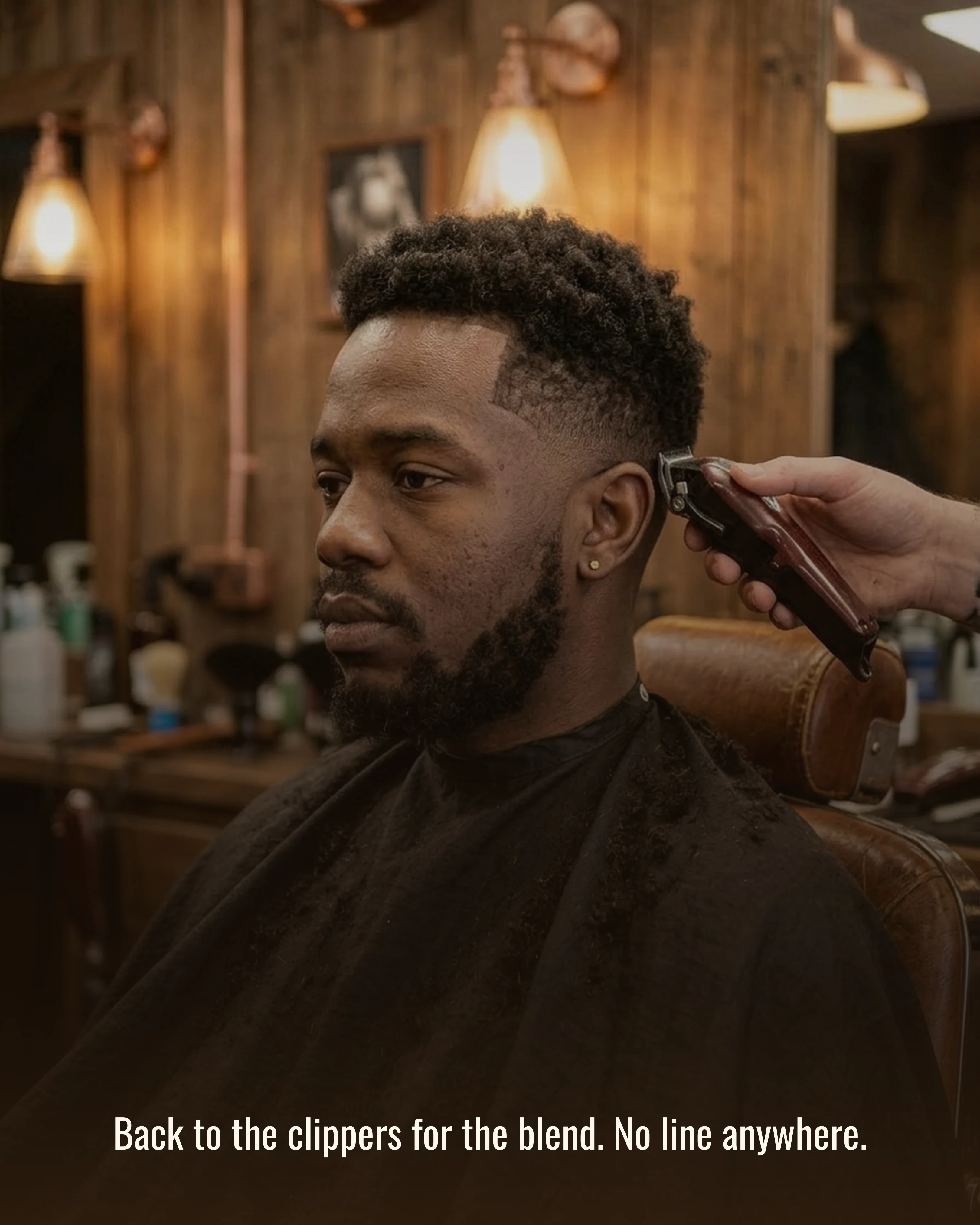 Clippers refining the blend on the side of the client's head